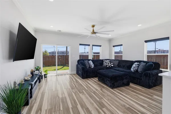 a living room with furniture a flat screen tv and a couch