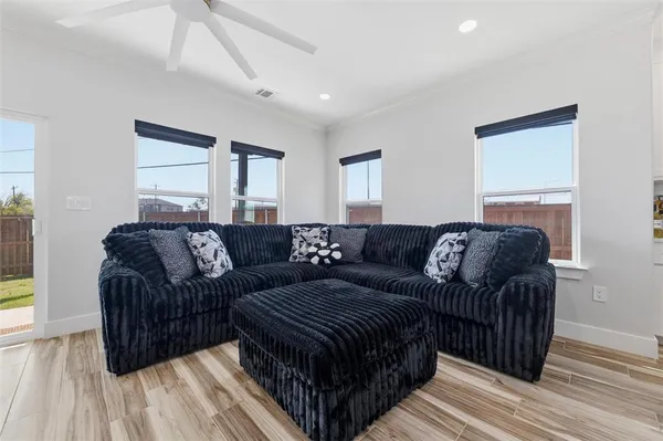 a living room with furniture and a chandelier