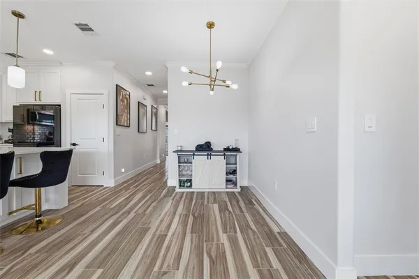a spacious bedroom with a bed a couch and a flat tv screen