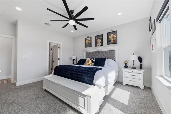 a bedroom with a bed a flat screen tv and a walk in closet