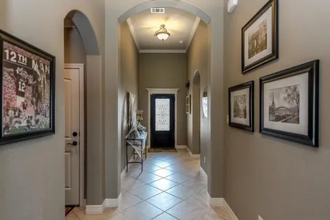 a view of a hallway with paintings on the wall