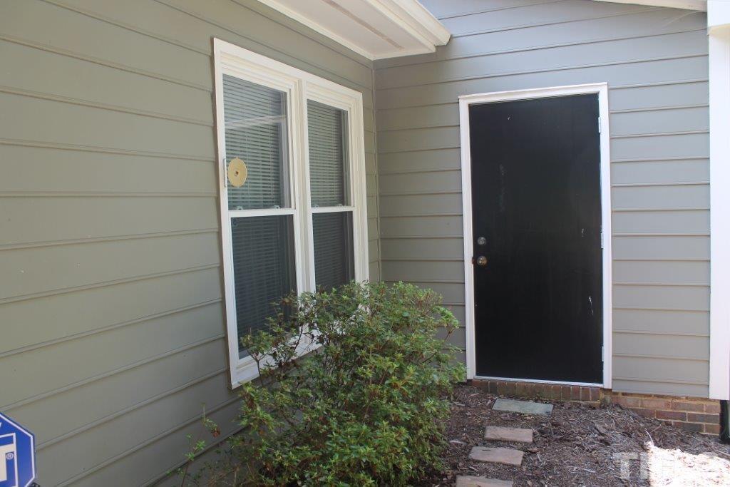 2707 Cottage Circle Raleigh, NC 27613 - Photo 20 of 21 a couple of potted plants in front of door