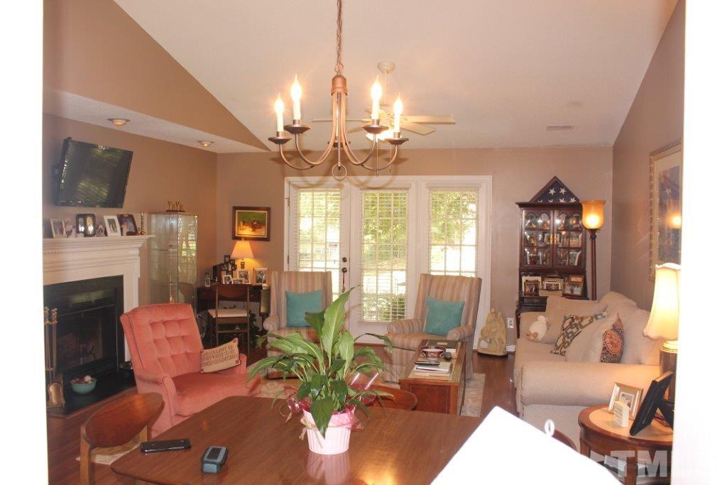 2707 Cottage Circle Raleigh, NC 27613 - Photo 3 of 21 a living room with fireplace furniture and a chandelier
