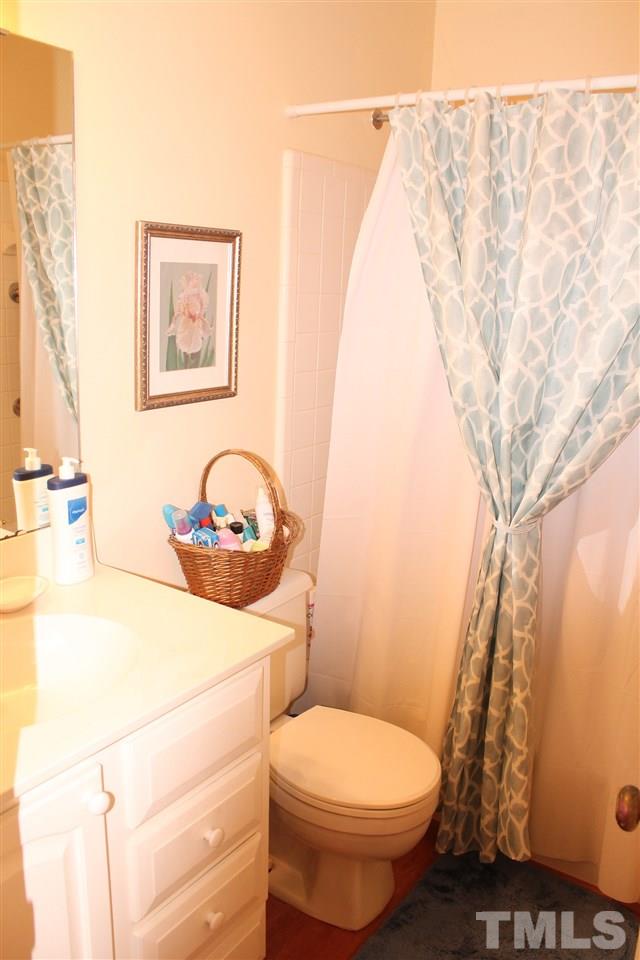 2707 Cottage Circle Raleigh, NC 27613 - Photo 21 of 21 a bathroom with a toilet sink and vanity