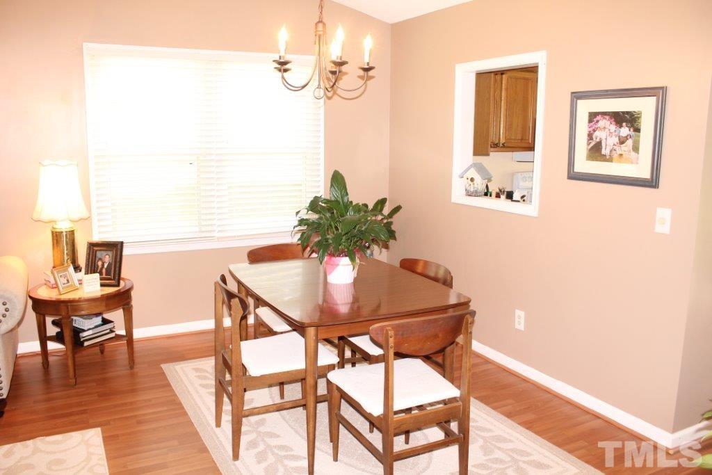 2707 Cottage Circle Raleigh, NC 27613 - Photo 6 of 21 a view of a dining room with furniture and wooden floor