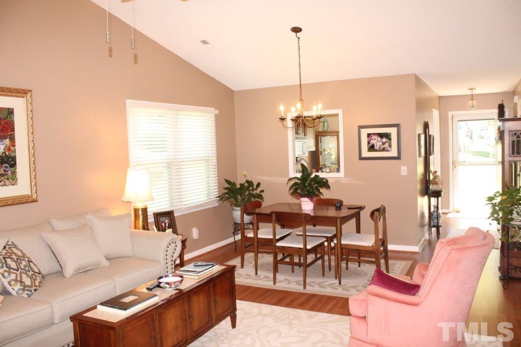 2707 Cottage Circle Raleigh, NC 27613 - Photo 7 of 21 a living room with furniture a dining table and a window