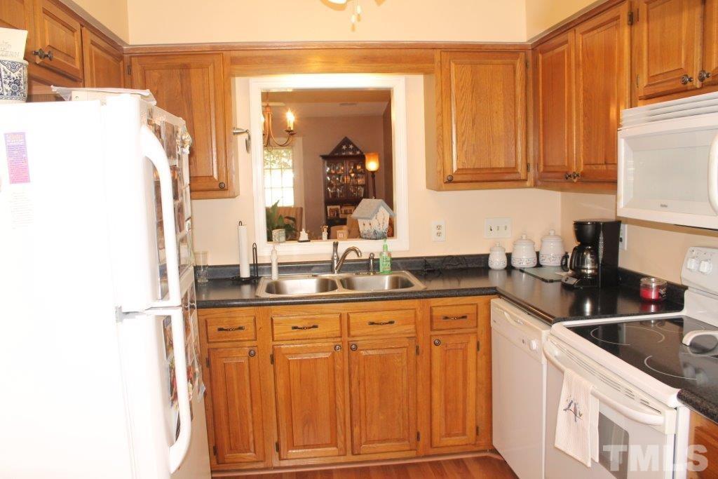 2707 Cottage Circle Raleigh, NC 27613 - Photo 8 of 21 a kitchen with granite countertop a sink and cabinets