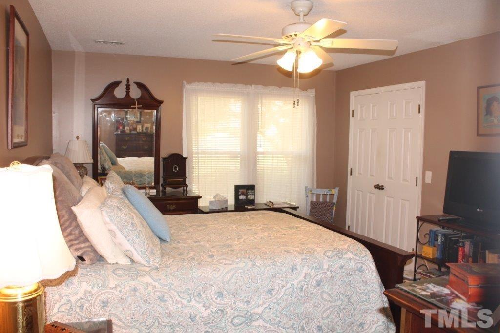 2707 Cottage Circle Raleigh, NC 27613 - Photo 10 of 21 a bedroom with a bed and a flat screen tv