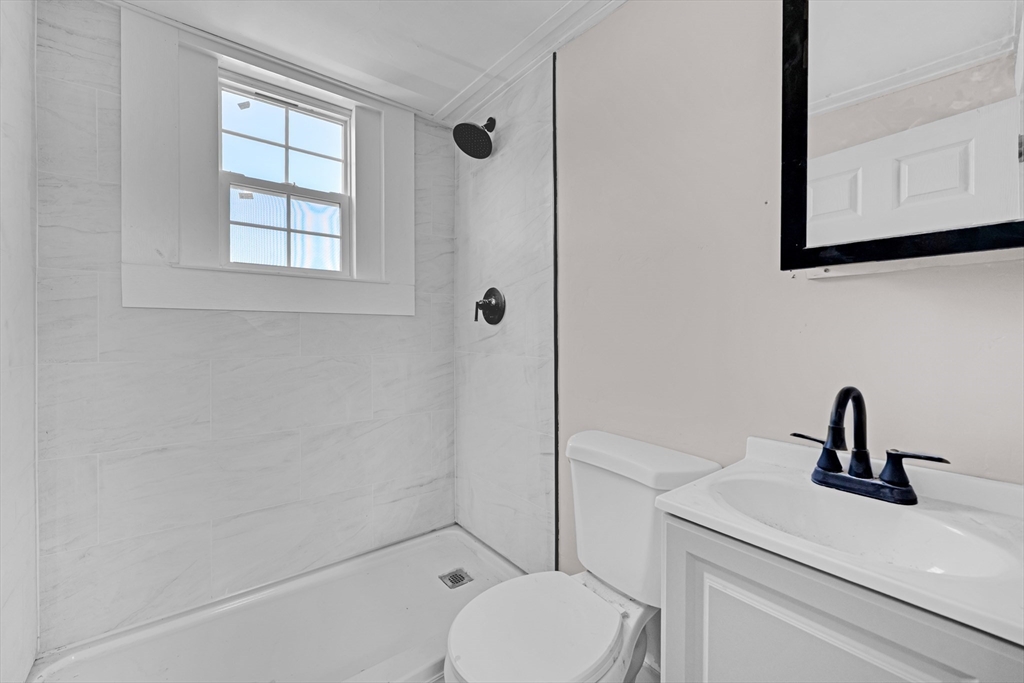 47 Morris Street Southbridge, MA 01550 - Photo 21 of 40 a bathroom with a toilet a sink and mirror