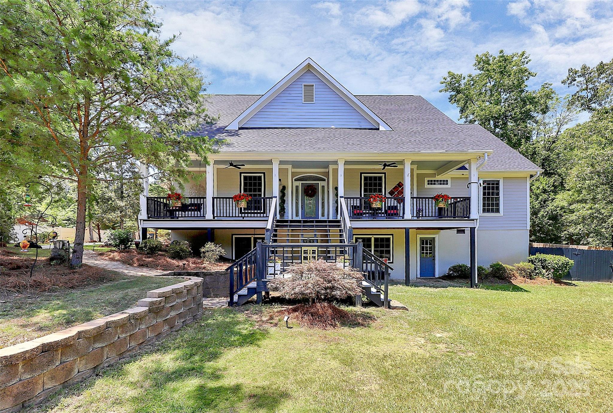 a front view of a house with a yard table and chairs