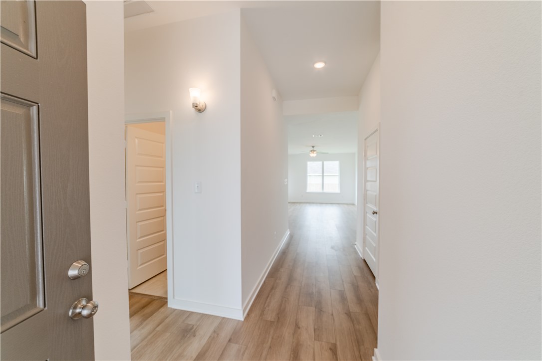 1901 Sebright Drive Bryan, TX 77807 - Photo 2 of 13 a view of a hallway with wooden floor and a bathroom