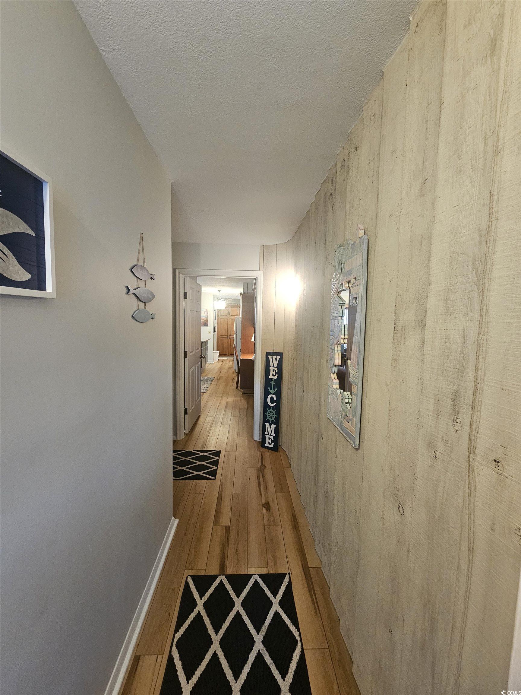 1910 South Ocean Boulevard, Unit C2 NASSAU I North Myrtle Beach, SC 29582 - Photo 2 of 12 Hall with wood finished floors and a textured ceiling