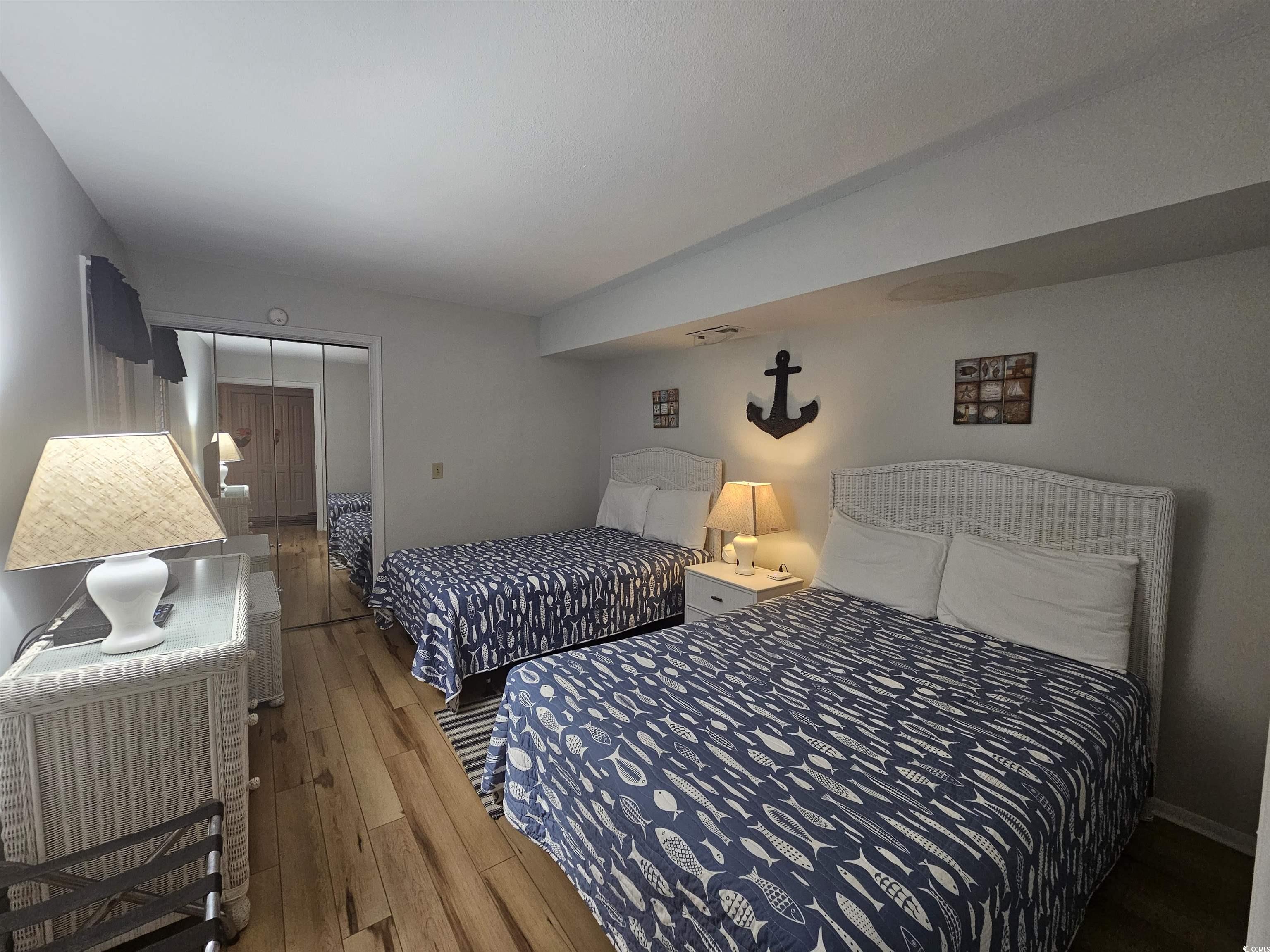 1910 South Ocean Boulevard, Unit C2 NASSAU I North Myrtle Beach, SC 29582 - Photo 3 of 12 Bedroom featuring hardwood / wood-style flooring and a closet