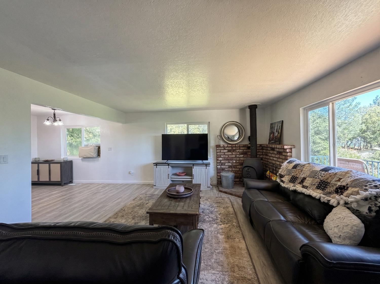19310 Branding Iron Road Penn Valley, CA 95946 - Photo 13 of 30 a living room with furniture and a flat screen tv