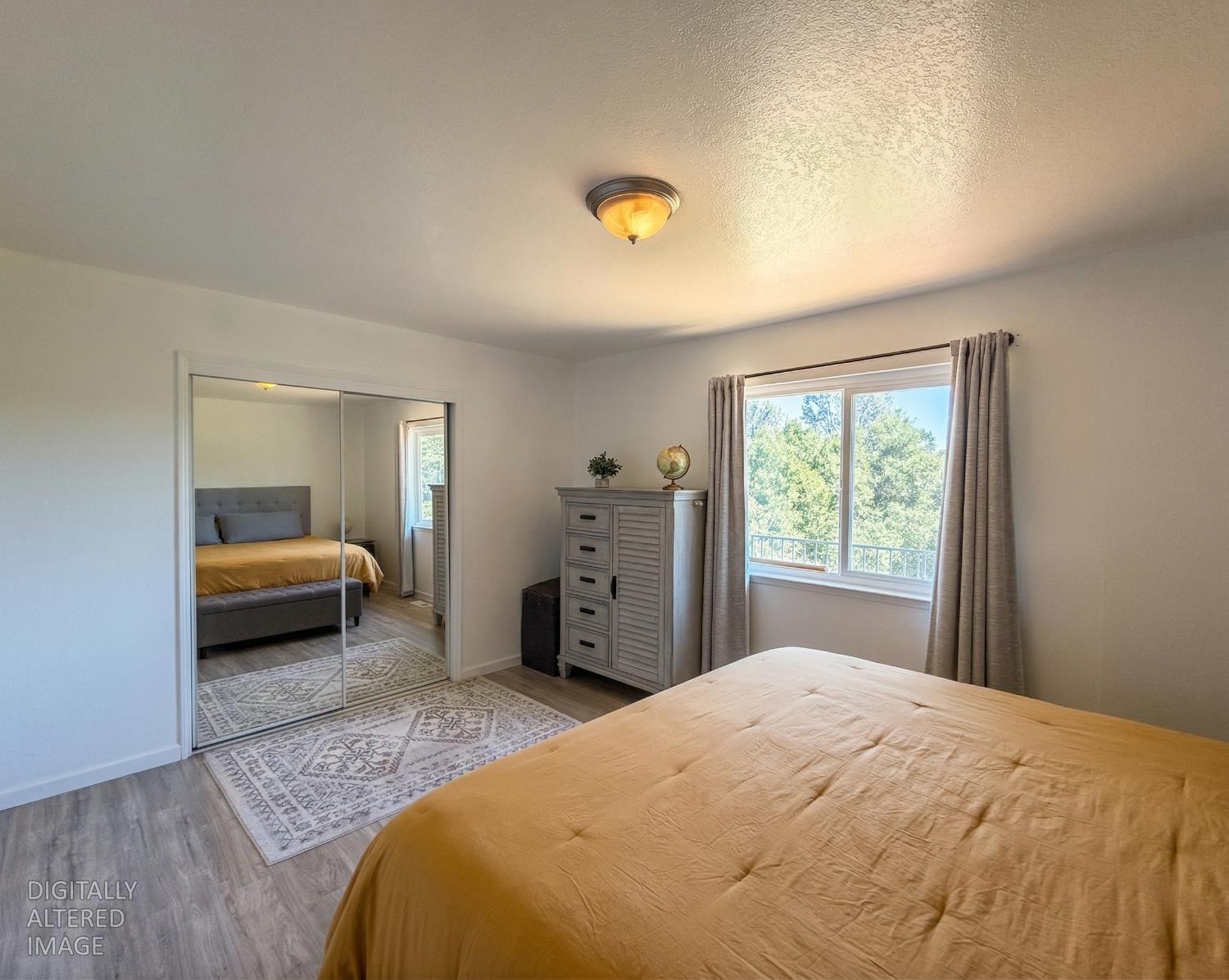 19310 Branding Iron Road Penn Valley, CA 95946 - Photo 19 of 30 a bedroom with a bed and a couch