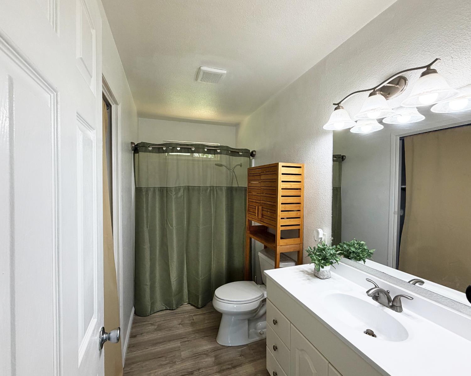 19310 Branding Iron Road Penn Valley, CA 95946 - Photo 20 of 30 a bathroom with a toilet a sink and mirror