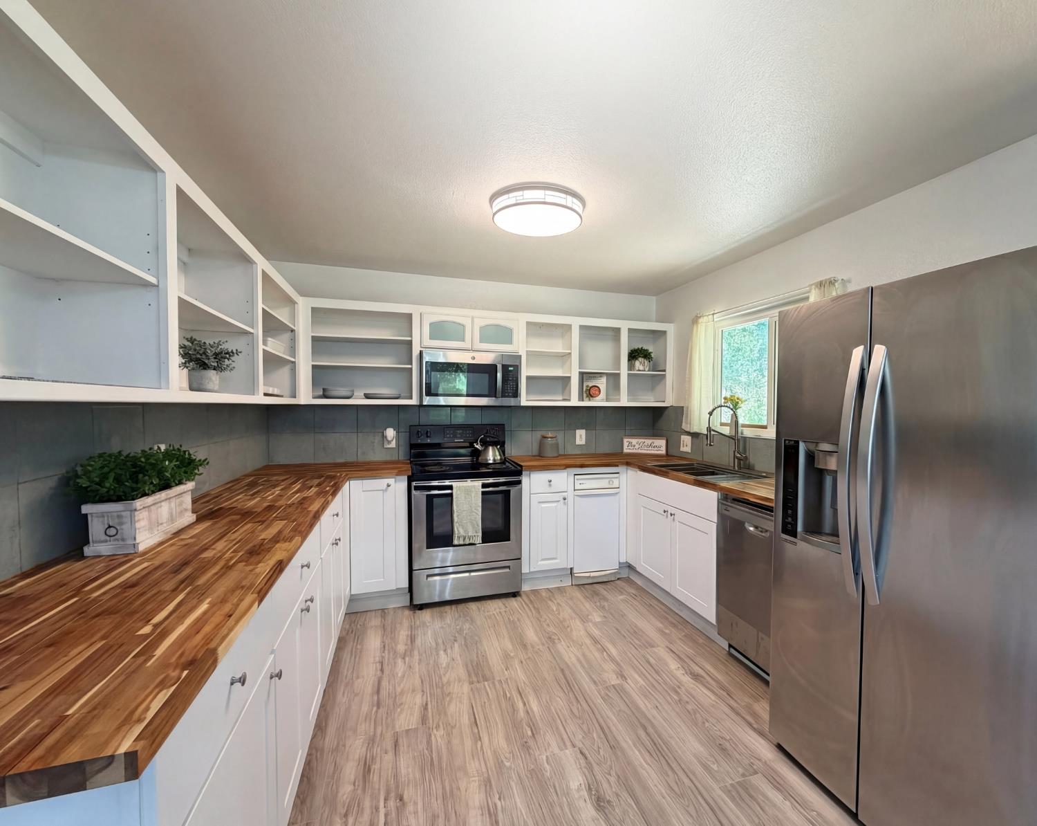 19310 Branding Iron Road Penn Valley, CA 95946 - Photo 3 of 30 a kitchen with stainless steel appliances a refrigerator and a stove top oven