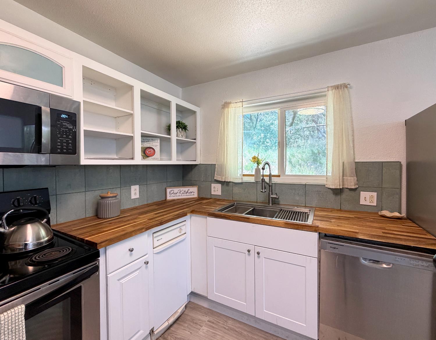 19310 Branding Iron Road Penn Valley, CA 95946 - Photo 9 of 30 a kitchen with a sink dishwasher window and cabinets