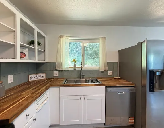a kitchen with a sink and a refrigerator