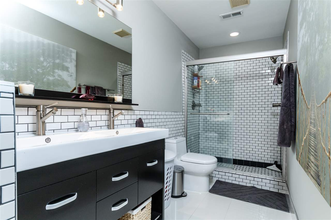 3412 1st Place Raleigh, NC 27613 - Photo 18 of 25 Such a relaxing feel to this home. Beautiful cabinets, tile and glass enclosed double shower. Double vanity and new decorative tile. Master Spa