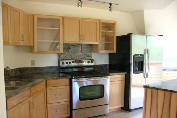 4608 Kuli Road Kalaheo, HI 96741 - Photo 3 of 15 a kitchen with stainless steel appliances granite countertop a stove a refrigerator and a microwave