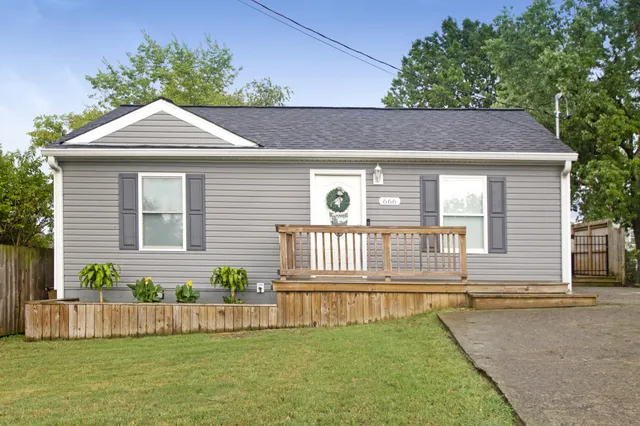 a front view of a house with a garden and yard