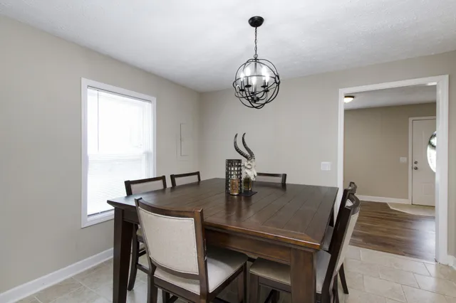 a view of a dining room with furniture wooden floor and chandelier