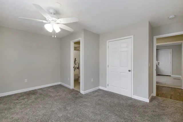 a view of an empty room with a fan