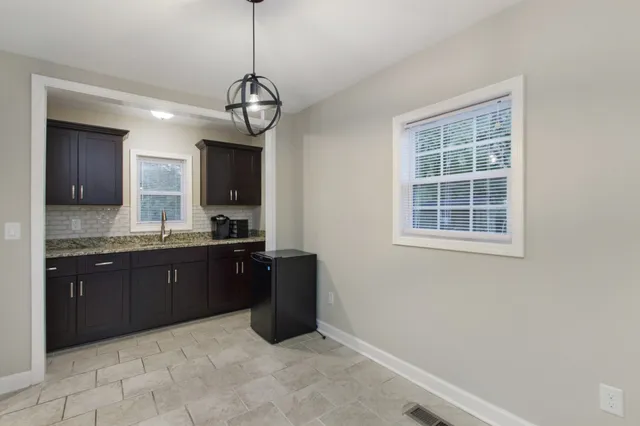 a kitchen with stainless steel appliances granite countertop a stove and cabinets