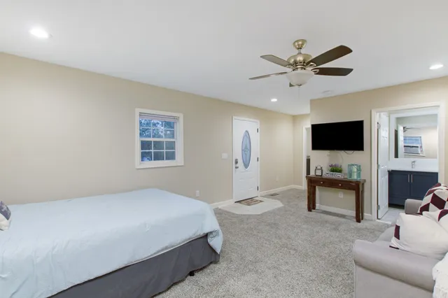 a bedroom with a bed and a flat screen tv