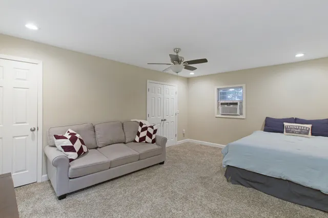 a living room with furniture and a ceiling fan