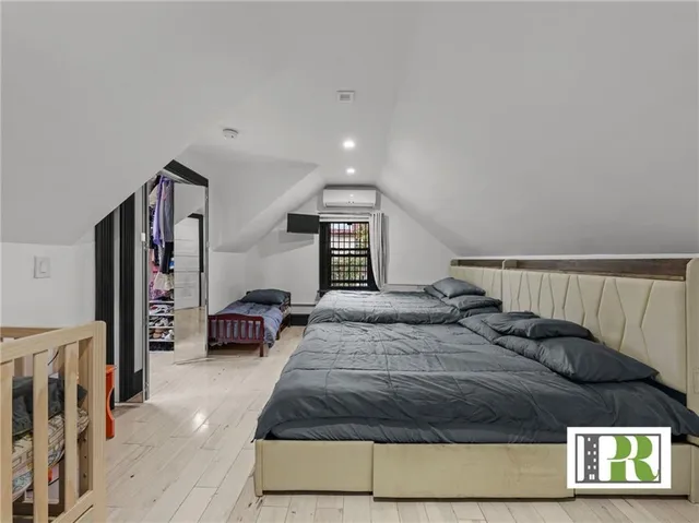 a bedroom with a large bed and a window