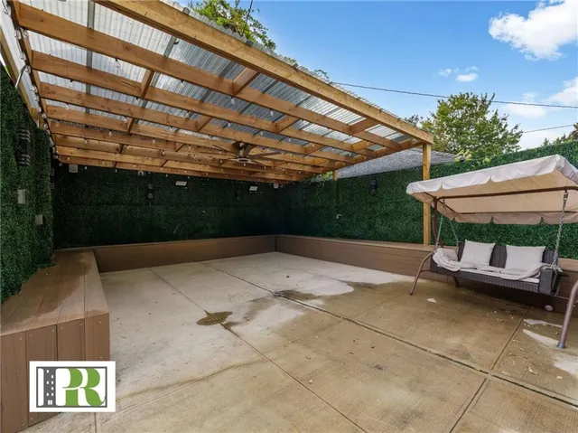 a view of patio with a table and chairs under an umbrella