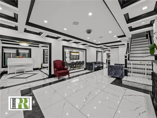 a lobby with furniture and a chandelier