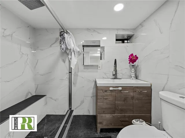 a bathroom with a toilet sink and shower