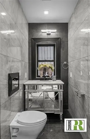 a bathroom with a toilet a sink and mirror