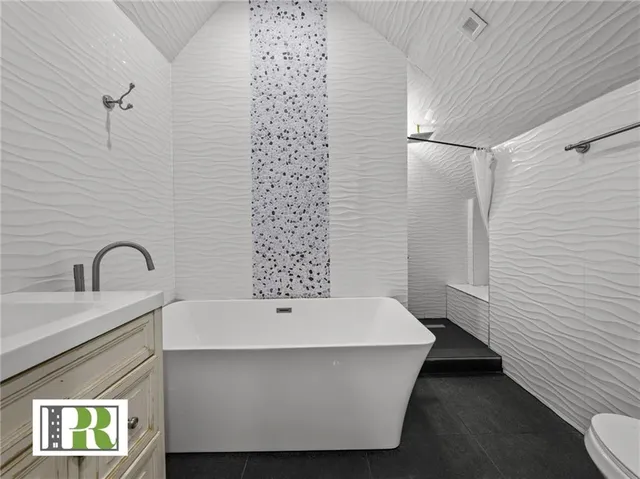 a bathroom with a bathtub and shower