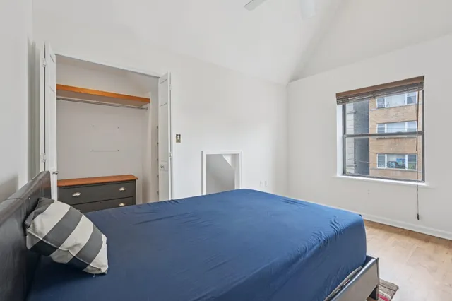 a bedroom with a bed and window