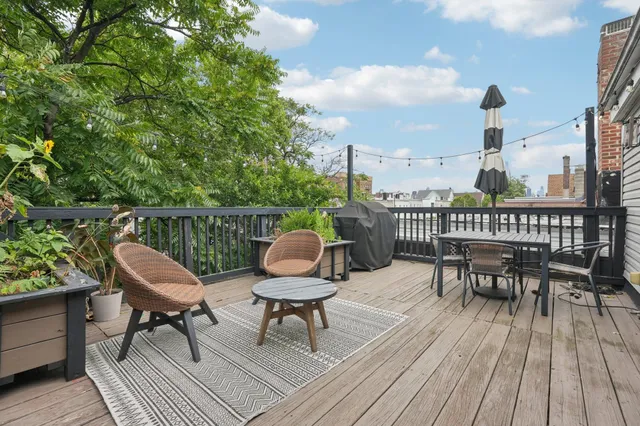 a outdoor view with a sitting space and large trees