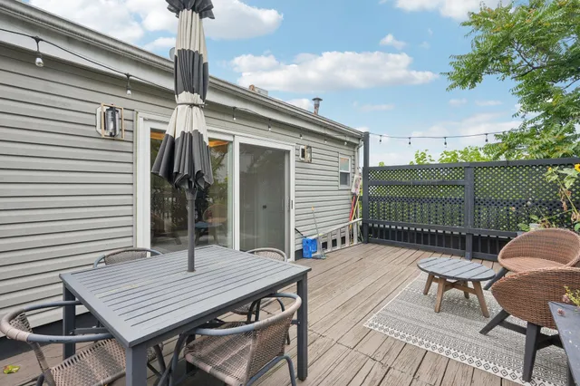 a balcony with table and chairs