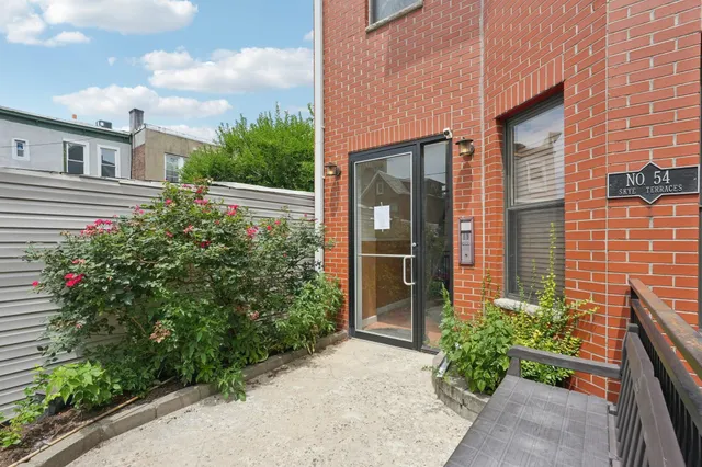 a view of a house with potted plants