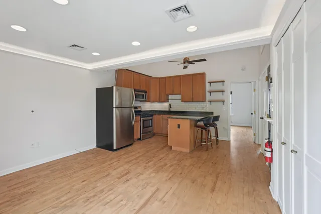a kitchen with stainless steel appliances a refrigerator and a stove top oven