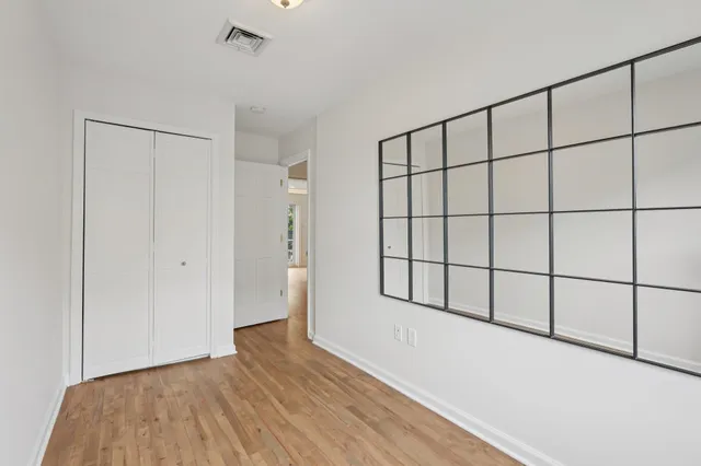 a view of a room with wooden floor and windows
