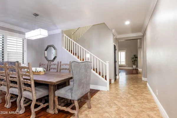 a view of a dining room with furniture and a chandelier