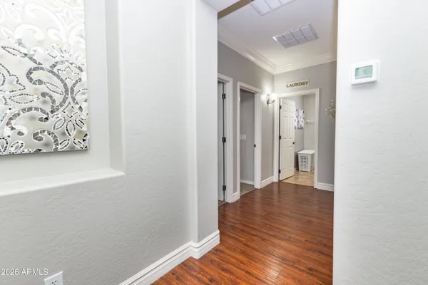 a view of a hallway with wooden floor