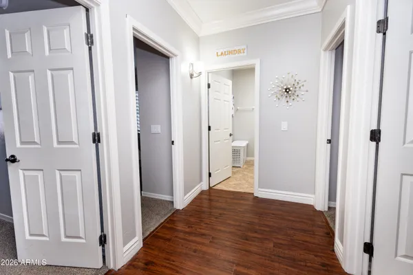 a view of a hallway with wooden floor