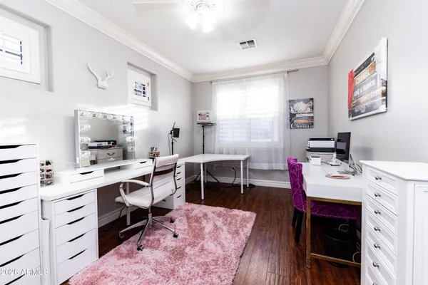 a view of a workspace with furniture and wooden floor