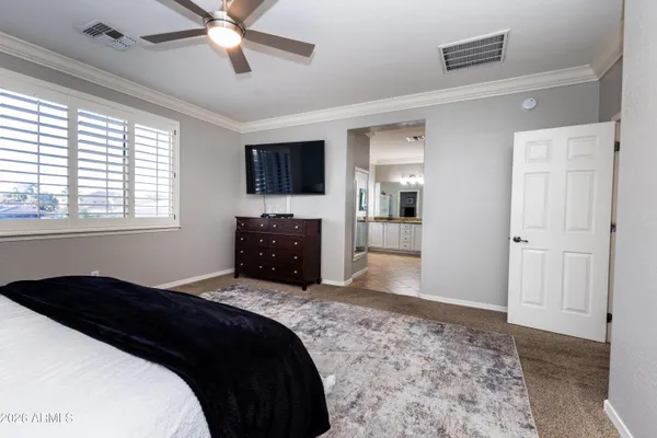 a bedroom with a bed and a television