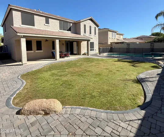 a view of a white building with swimming pool in front of it