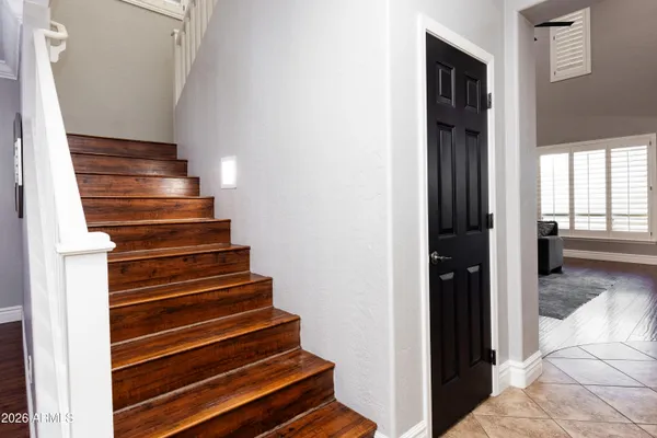 a view of entryway and hall with wooden floor